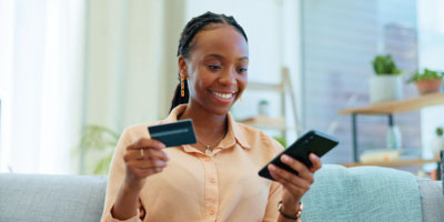 woman shopping with debit card on phone