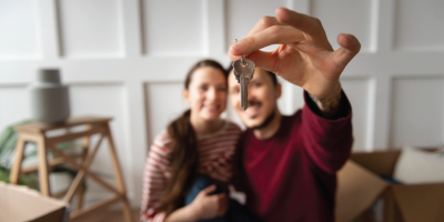 couple holding keys to home